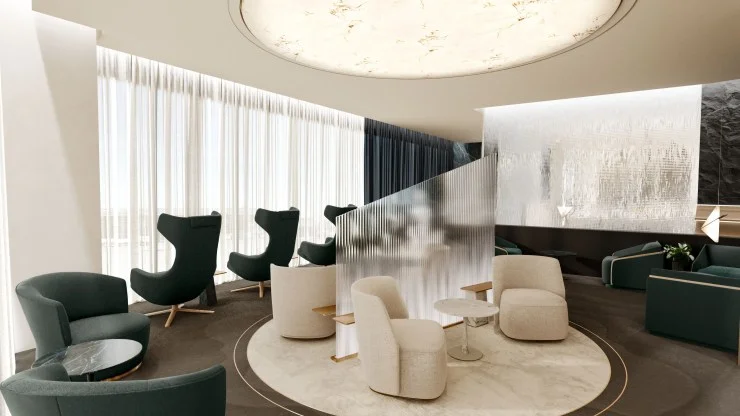 Modern lounge area featuring stylish seating arrangements with green and white chairs, a round marble coffee table, and soft lighting from a decorative ceiling fixture.