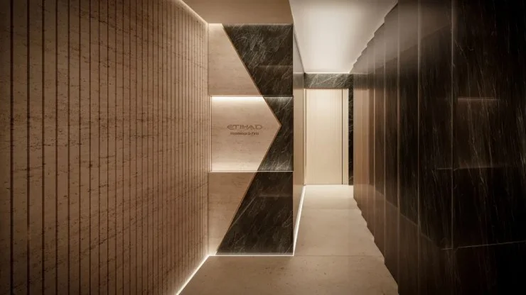 Interior view of a stylish hallway featuring textured walls and modern lighting, labeled 'ETIHAD Residence & First'.
