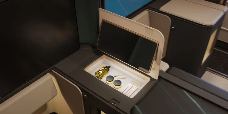 A close-up view of a modern airplane cabin feature, showcasing a storage compartment with a small mirror, a bottle, and containers inside.