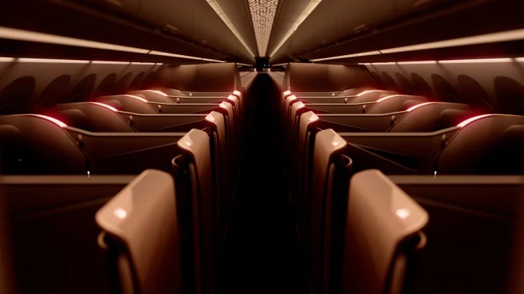 Interior view of an airplane cabin with illuminated seats and a modern design.