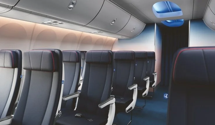 Interior view of an aircraft cabin featuring modern black and blue seating with sleek design elements.
