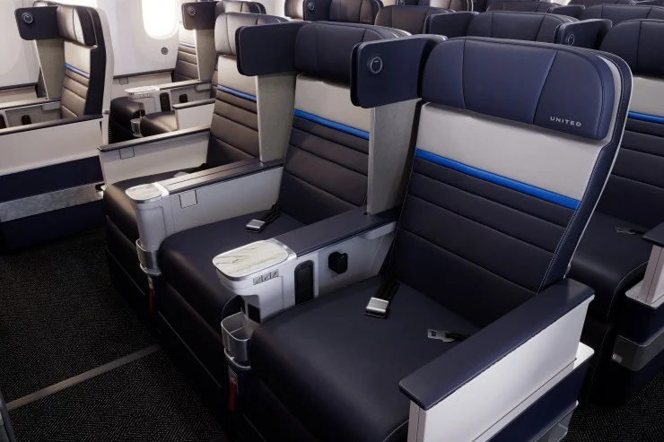 Interior view of United Airlines' new business class cabin showcasing upgraded seating with modern design elements.