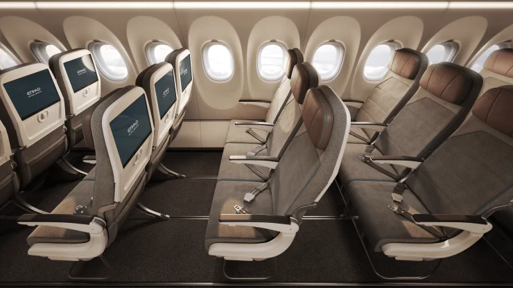 Interior view of an Etihad A321LR cabin showcasing Economy Class seating with patterned upholstery and large windows.