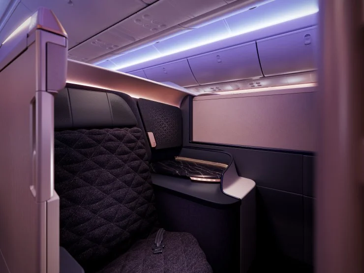 Interior view of a luxurious Business Class seat on Riyadh Air, featuring modern design elements, elegant lighting, and high-quality materials.