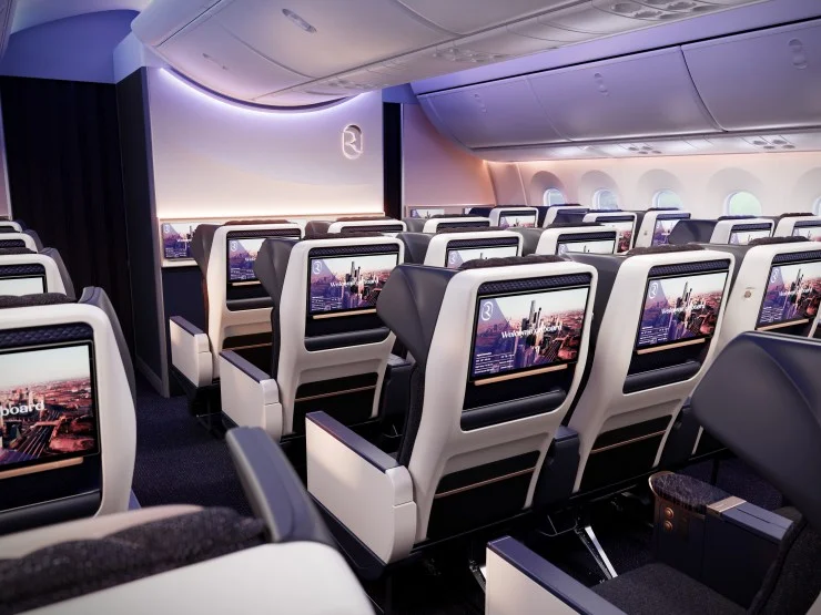 Interior view of Riyadh Air's premium economy cabin featuring modern seating, personal entertainment screens, and elegant lighting.